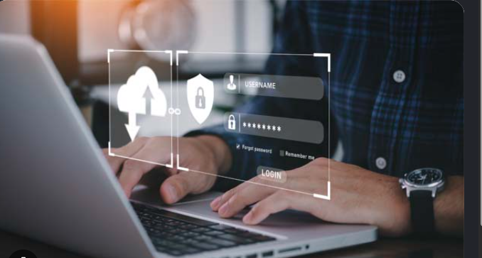 Person using a laptop with login credentials and security lock graphics