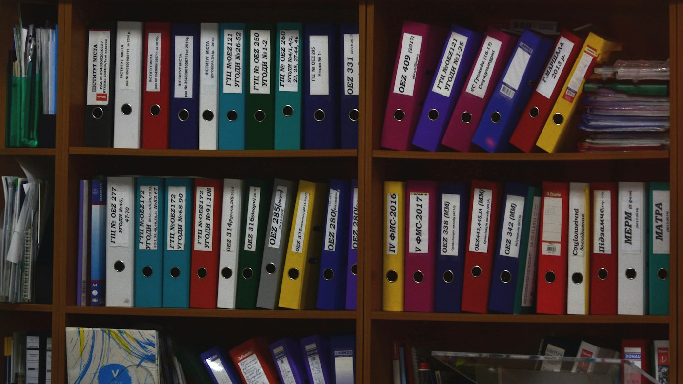 Organized rows of labeled document binders