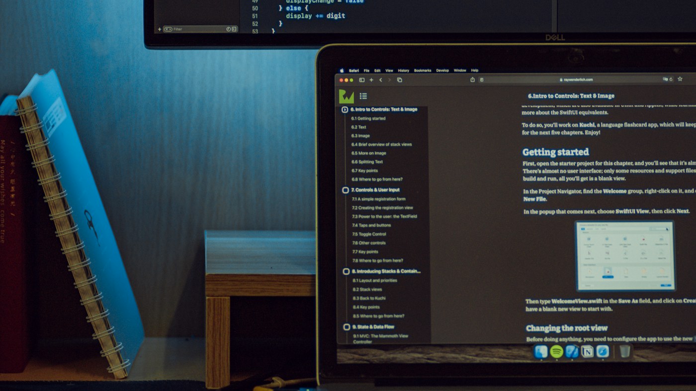 Laptop and monitor displaying software development tools